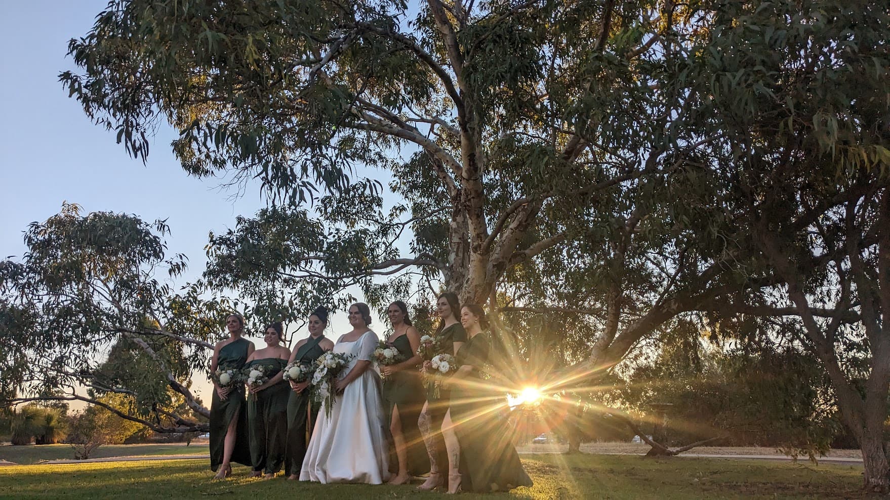 A bridal party at golden hour in custom made dresses