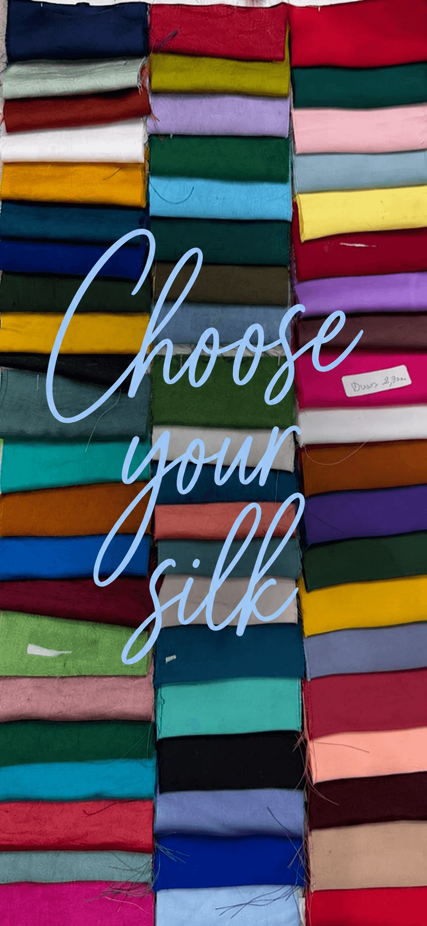A wall of folded silk swatches in every colour, choose your fabric for custom bridesmaid dresses