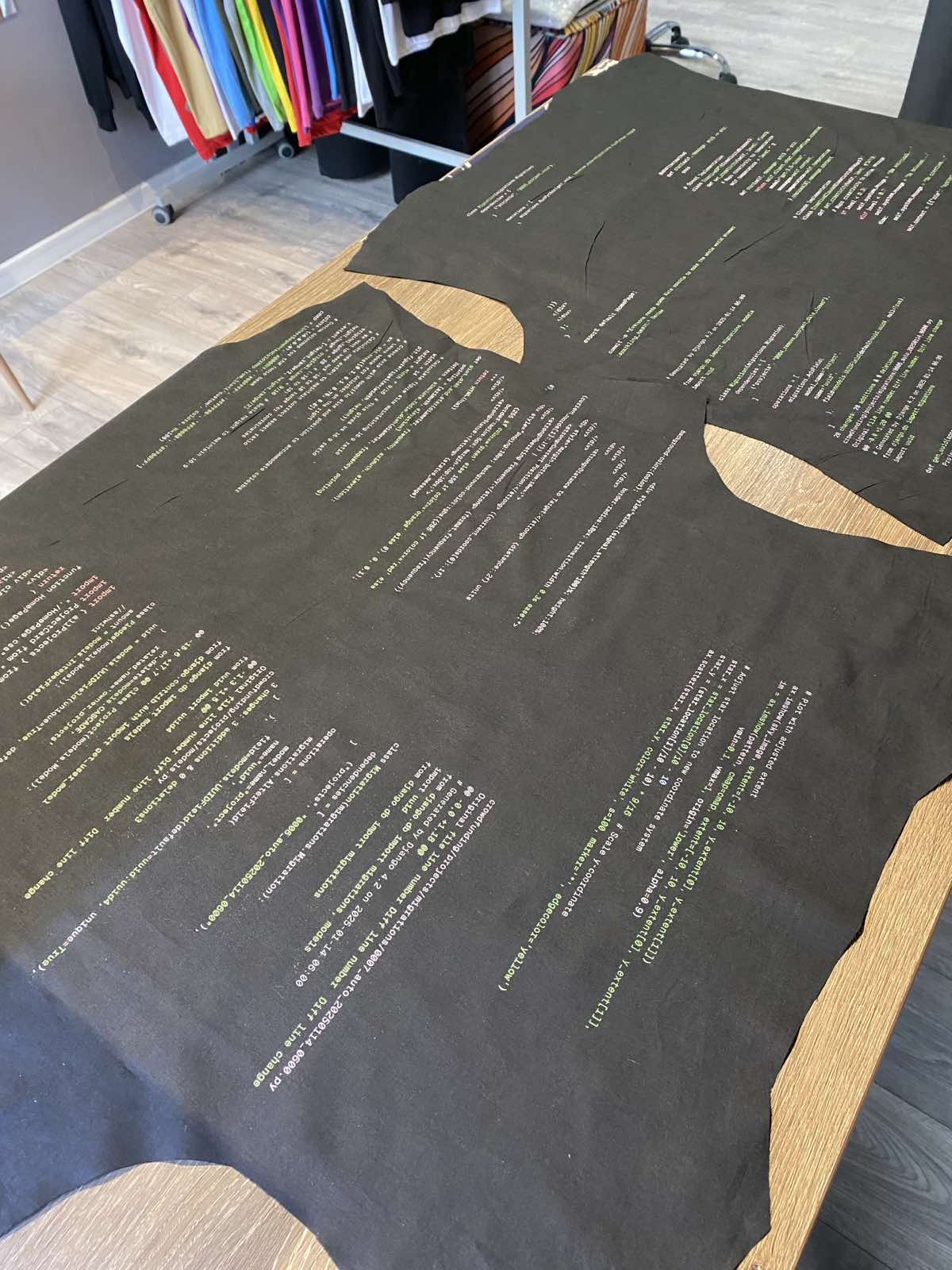 Custom fabric printed with code, laid out for cutting