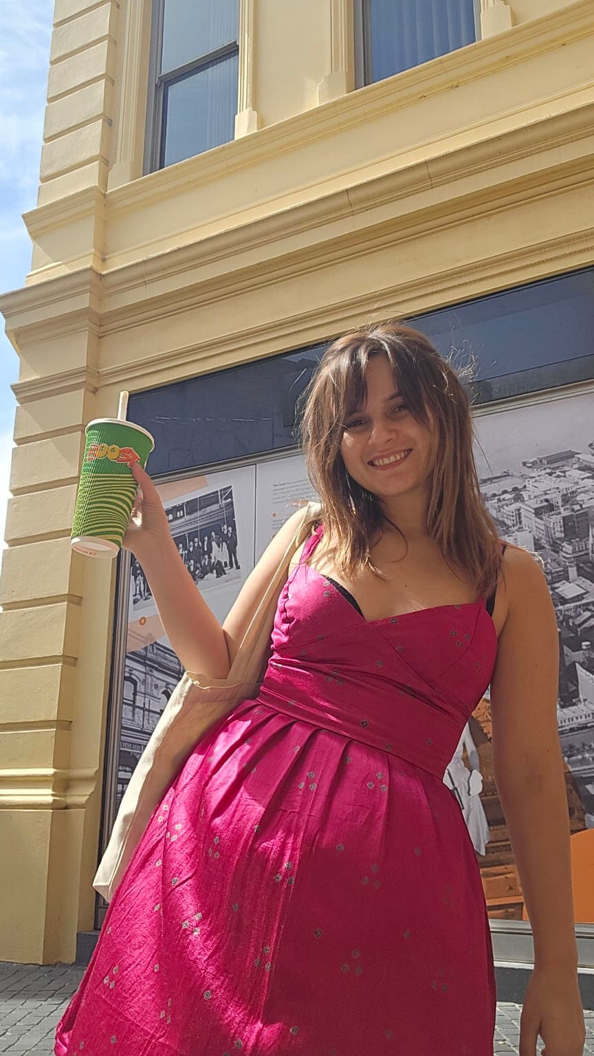 A woman in a magenta shot-silk custom dress