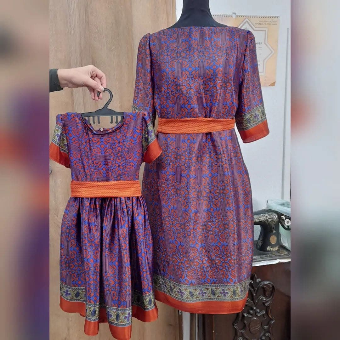Matching custom mother-and-daughter dresses in a printed silk