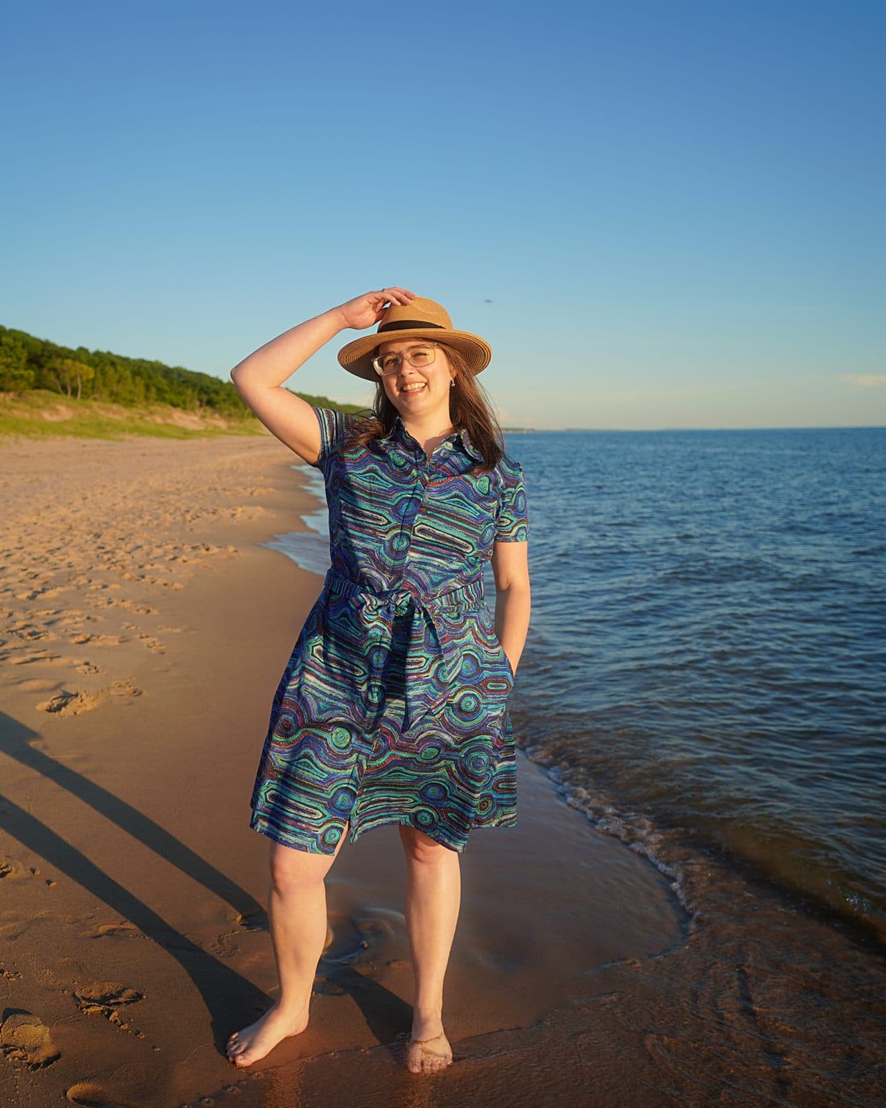 Mary wearing her custom Emu Dreaming shirt dress by the lake.