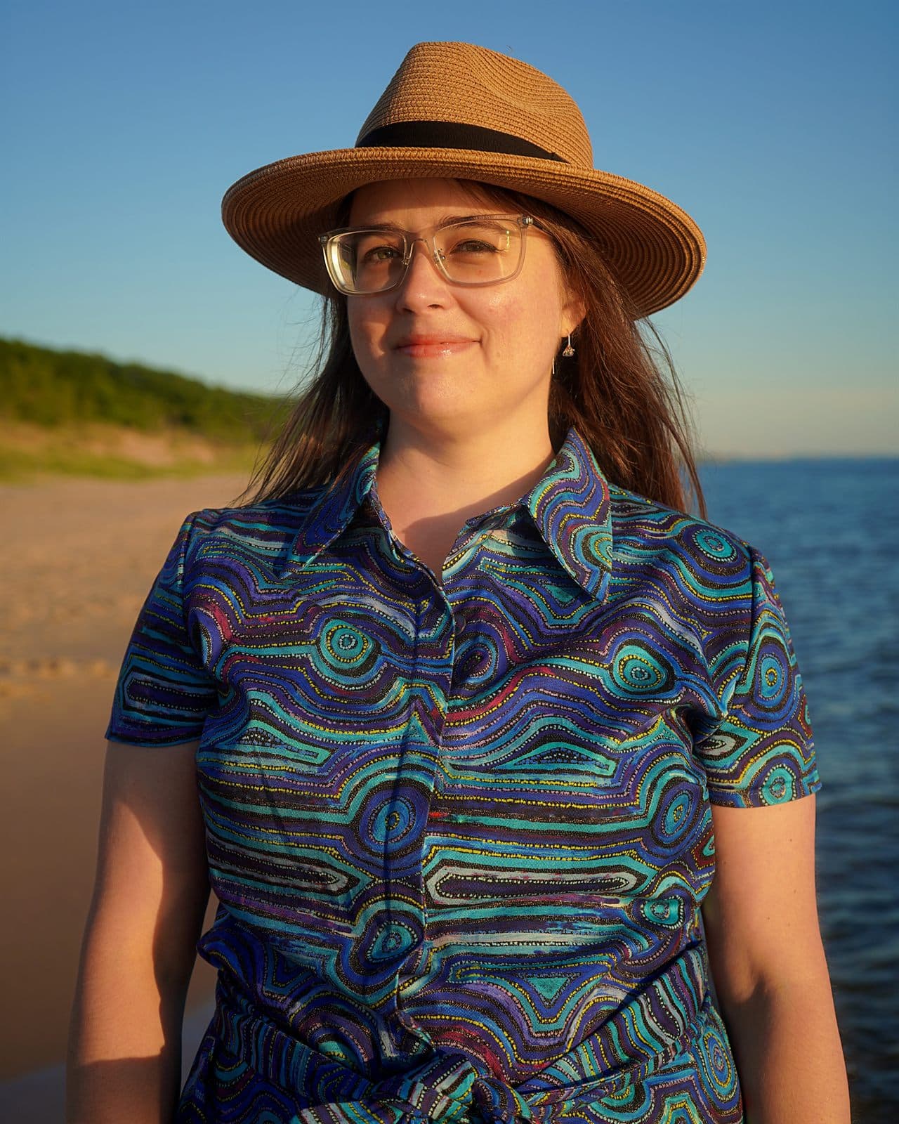 Mary wearing her custom Emu Dreaming shirt dress by the lake