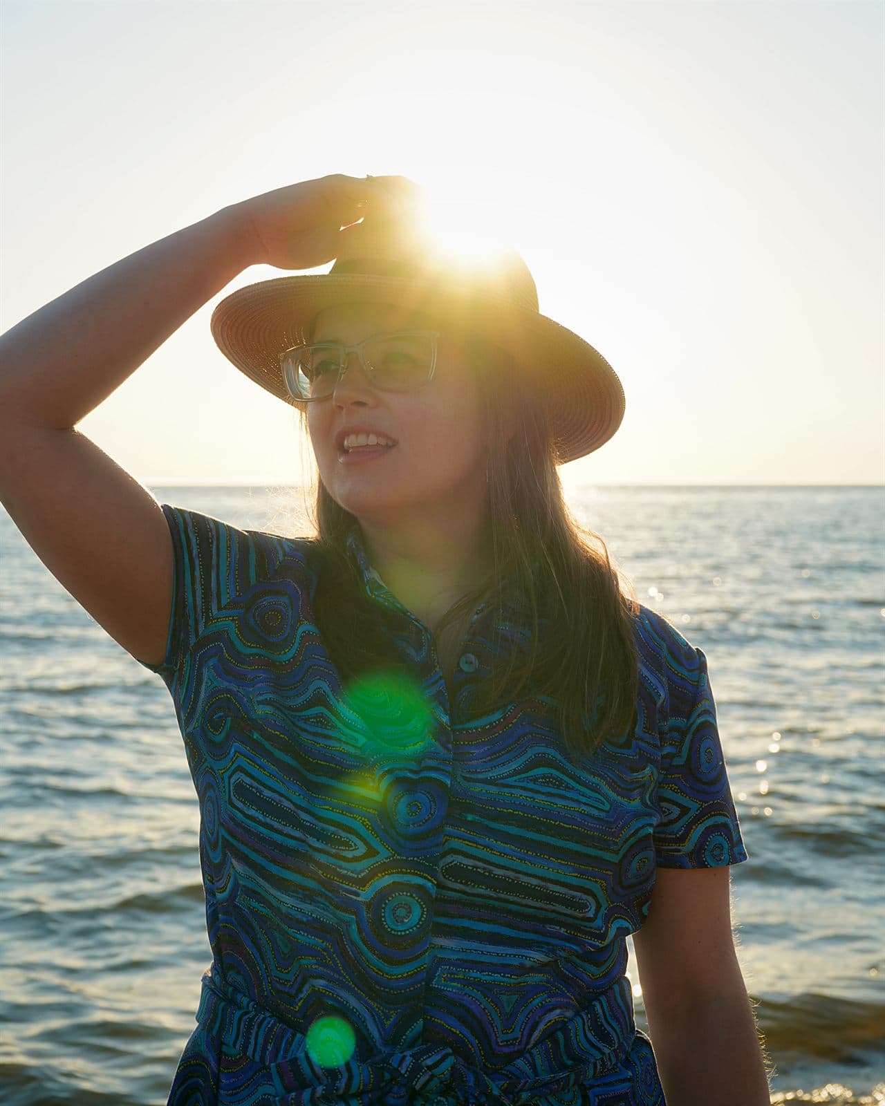 Mary in her custom Emu Dreaming shirt dress at sunset by the lake.