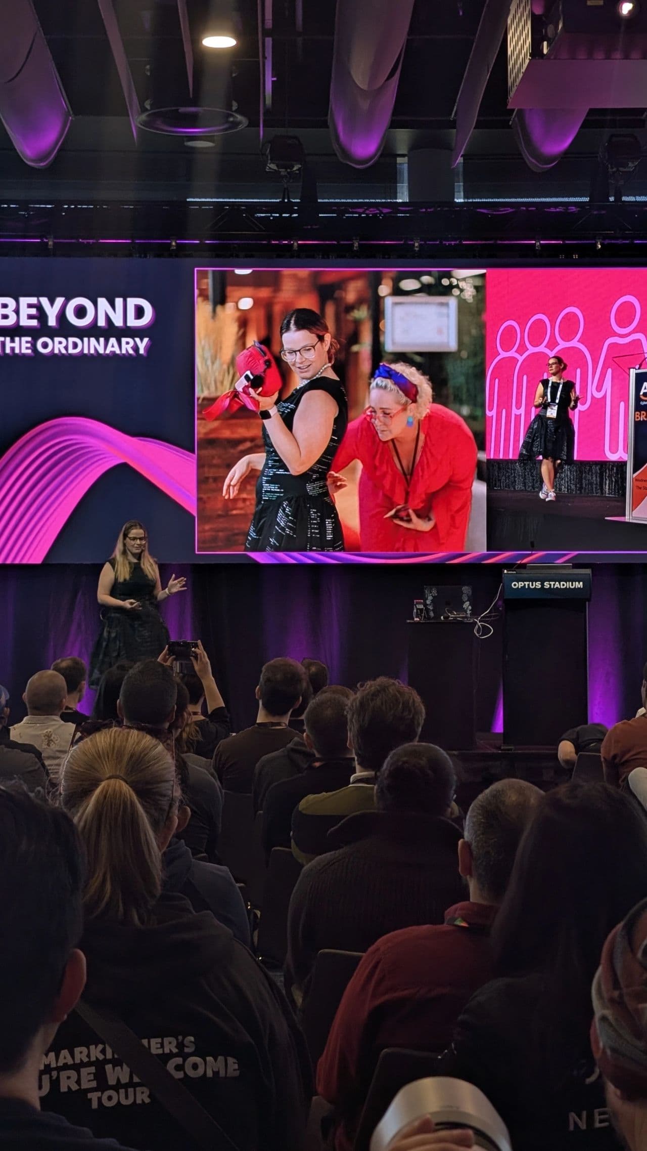 A speaker on stage in a custom dress designed for the full 360-degree view