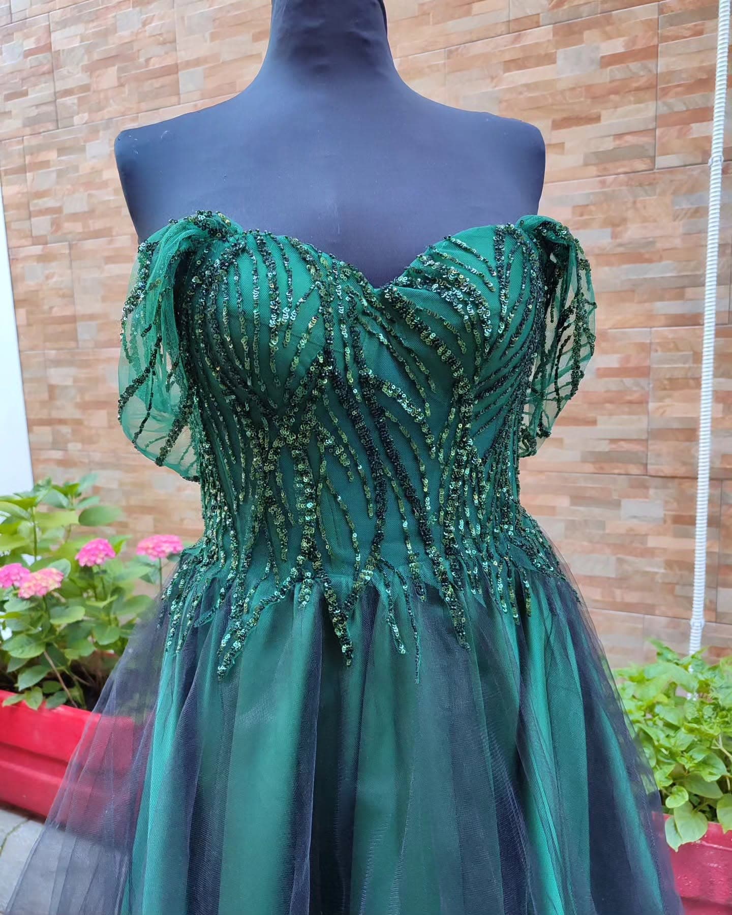 Hand-beaded emerald sequin embroidery across the bodice of a custom occasion gown