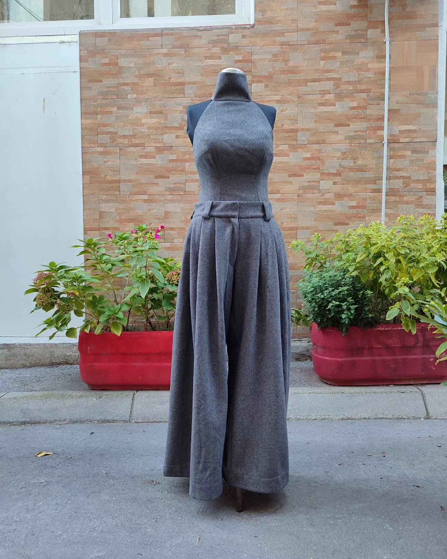 A custom grey wool halter top and full-length wide-leg trousers — fitted through the bodice and hips, with true length through the leg